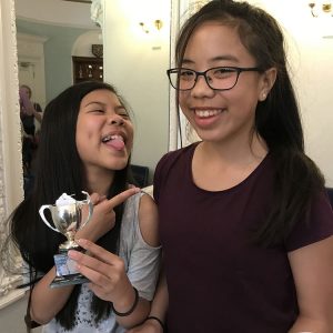 Photo of Sasha & Yasmin Ng with their shared trophy