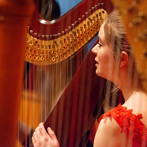 Photo of a young harp player from the NYHO